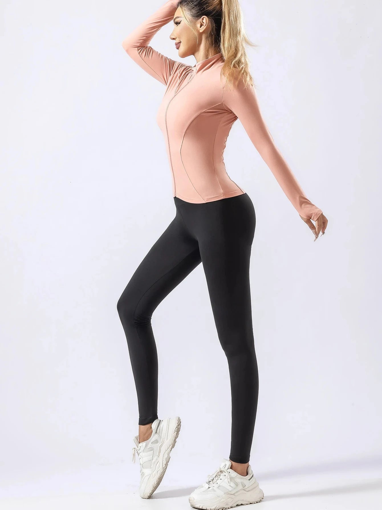 "Pink fitted yoga top with black leggings for women, featuring quick-dry fabric for autumn and winter gym or running sessions."