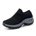 Black athletic shoe with gray sole on a white background