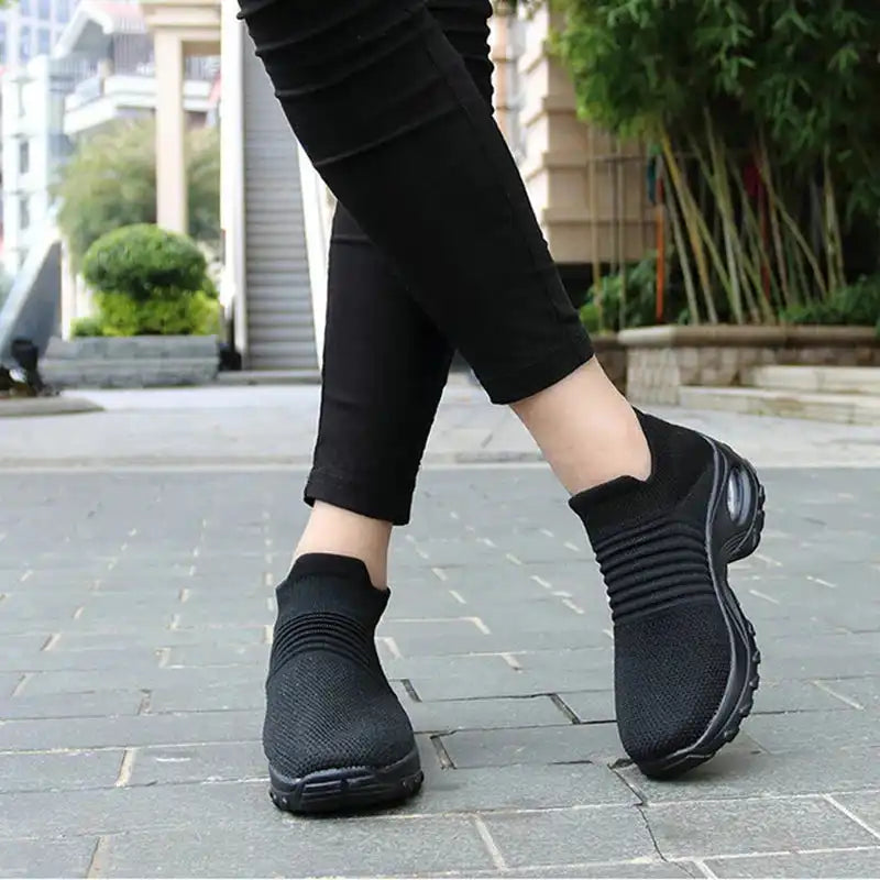 "Women Sneakers Fashion Breathable Walking Mesh Platform Shoes in black with slip-on design and cushioned sole for gym or casual wear."