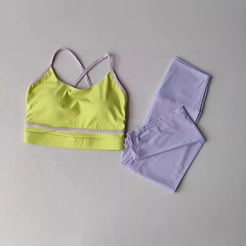 Yellow sports bra and purple leggings on a gray background