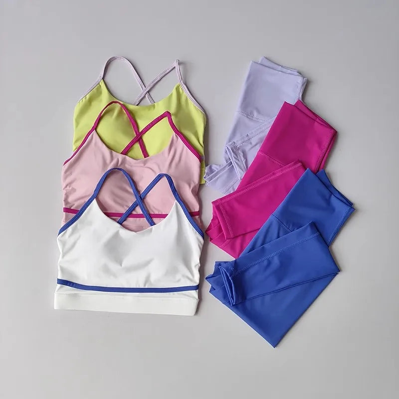 Colorful sports bra and leggings set on a gray background
