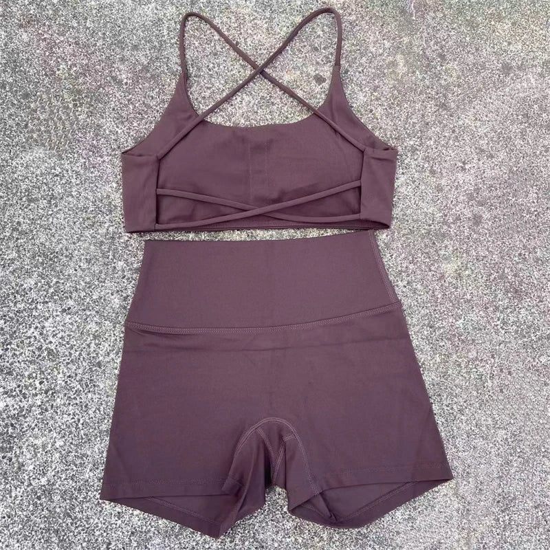 Purple sports bra and shorts set on a textured surface