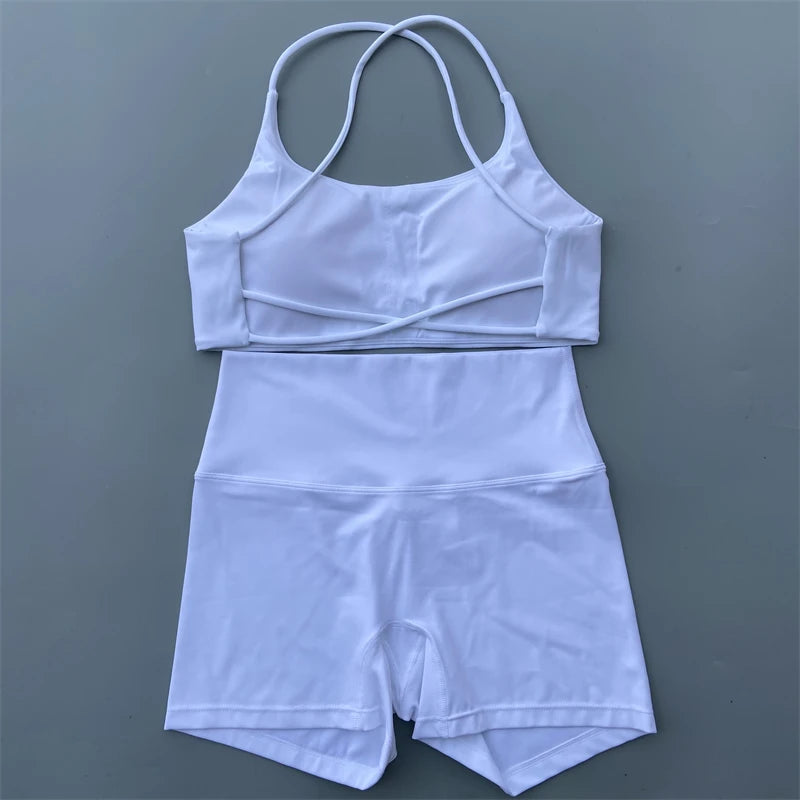 Light blue sports outfit with top and shorts on a gray background