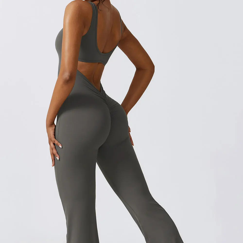 Person wearing a gray sports bra and leggings on a light gray background