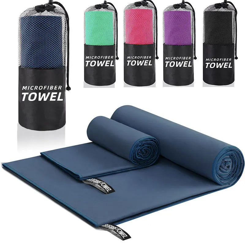 Set of microfiber towels in various colors with carrying cases on a white background.
