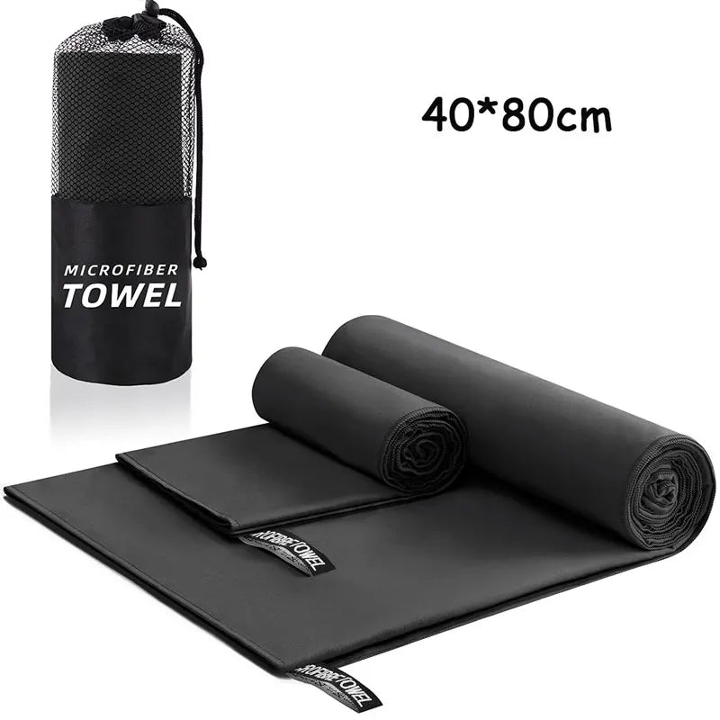 Black microfiber towel with carrying case on a white background