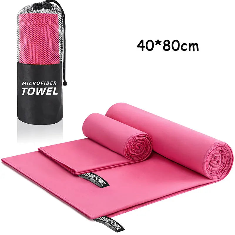 Pink microfiber towel with carrying case on a white background