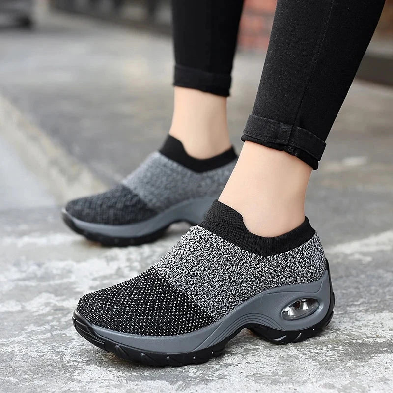 Women Sneakers Fashion Breathable Walking Mesh Platform Shoes in black with slip-on design and cushioned sole for gym or casual wear.