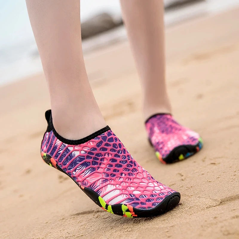 Unisex quick-drying aqua shoes in vibrant pink pattern, ideal for beach and outdoor activities, lightweight and slip-on design.