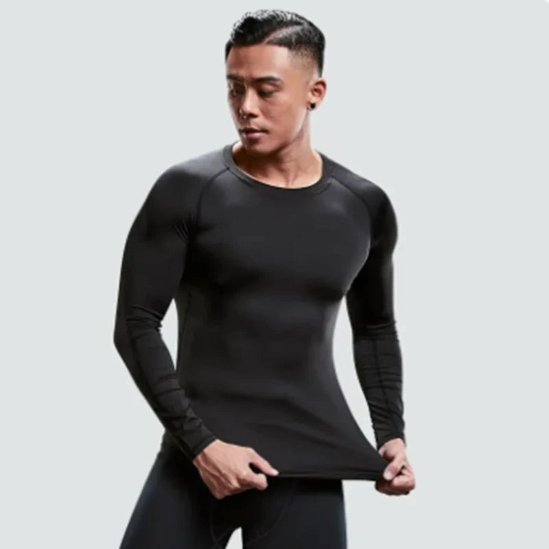 Model stretching black compression shirt from Men's Sports Suit Running fitne male Quick drying Sportswear Compression Clothing Fitness Training kit.