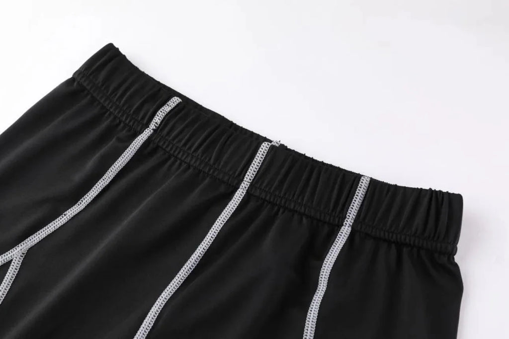 Elastic waistband with contrast stitching on black Men Bodybuilding Sportswear Clothes Fitness Suit pants for secure fit.