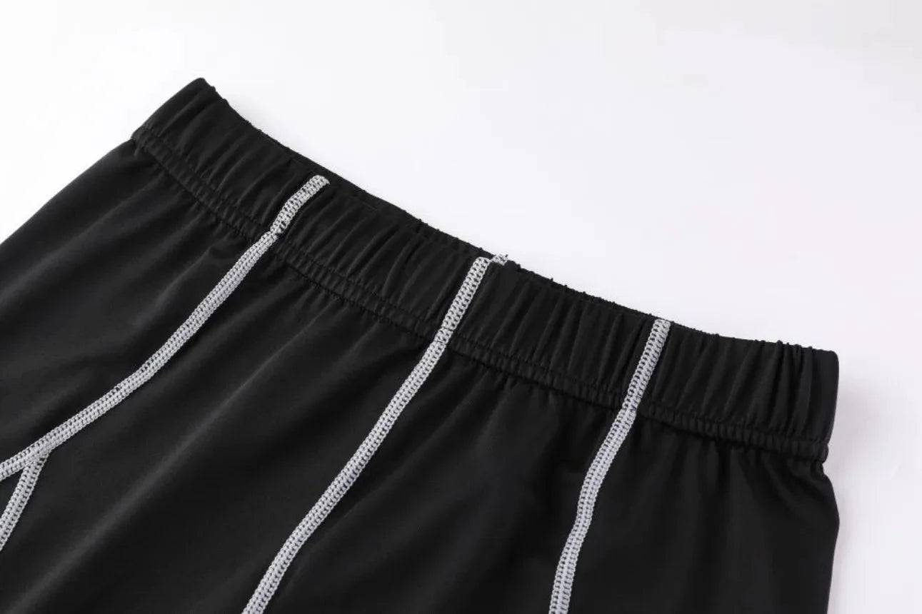 Elastic waistband with contrast stitching on black Men Bodybuilding Sportswear Clothes Fitness Suit pants for secure fit.