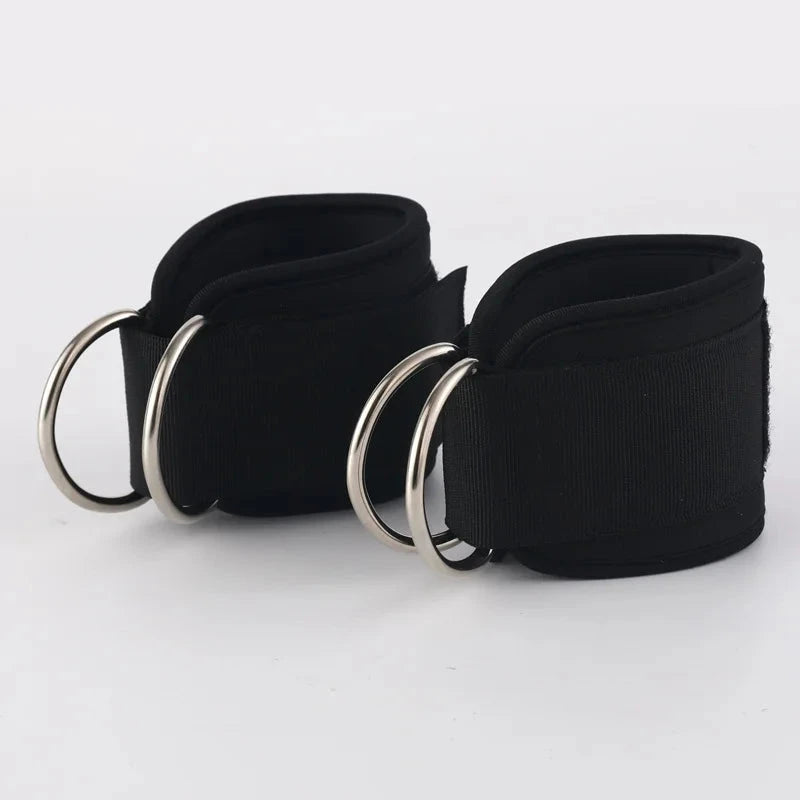 Pair of black fitness ankle loops with reinforced stitching and metal D-rings. Perfect for leg and glute exercises with resistance bands.