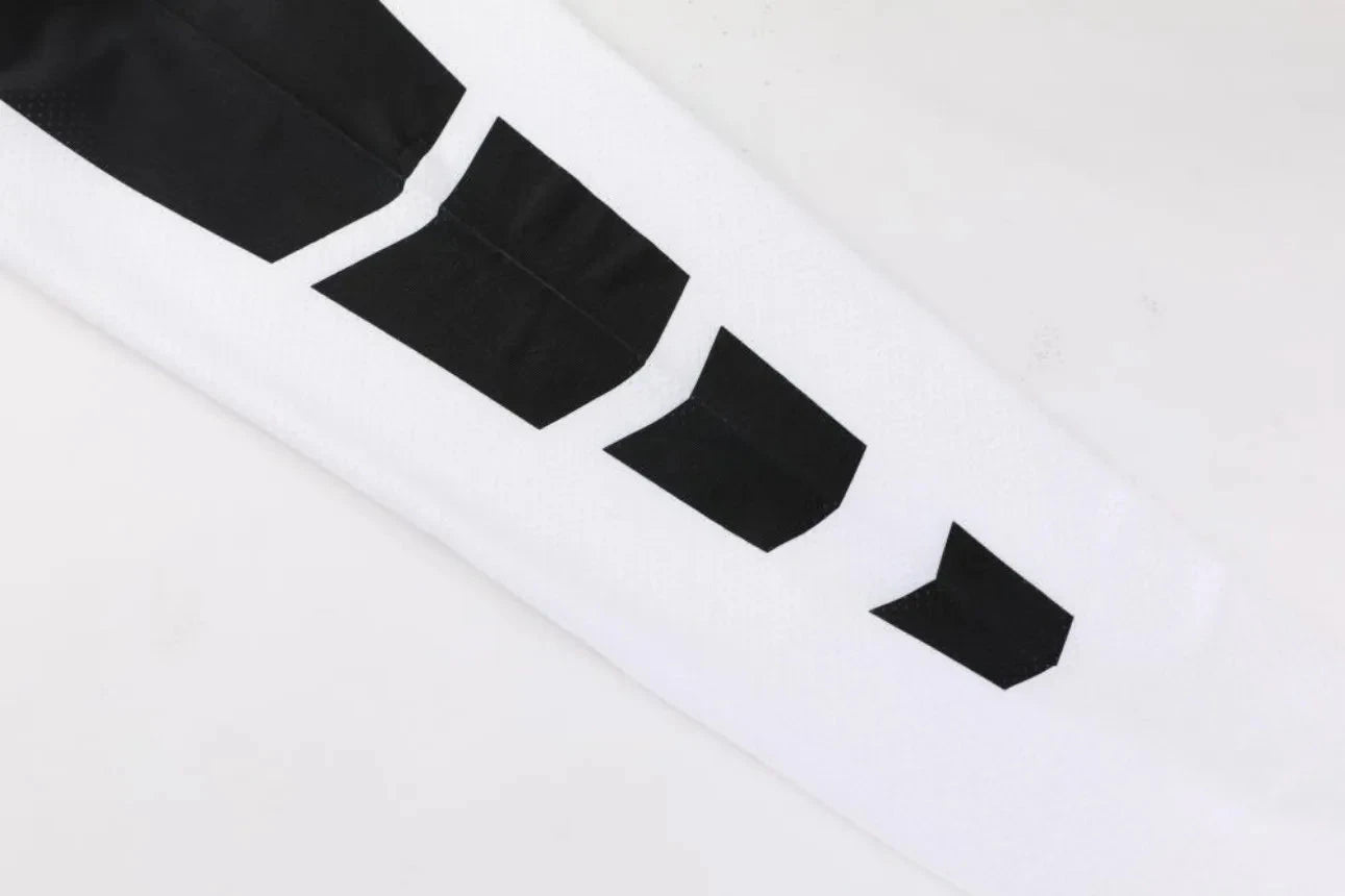 Close-up of black graphic design on white sleeve from Men Bodybuilding Sportswear Clothes Fitness Suit for visual appeal.