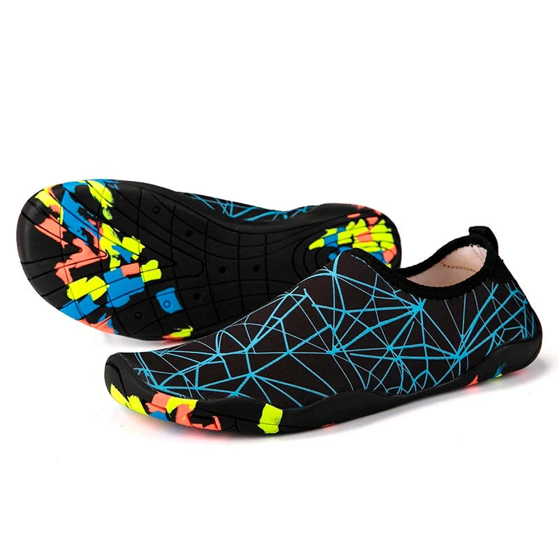 Unisex black aqua shoes with colorful geometric pattern, slip-on design, lightweight, quick-drying, perfect for beach and gym activities.