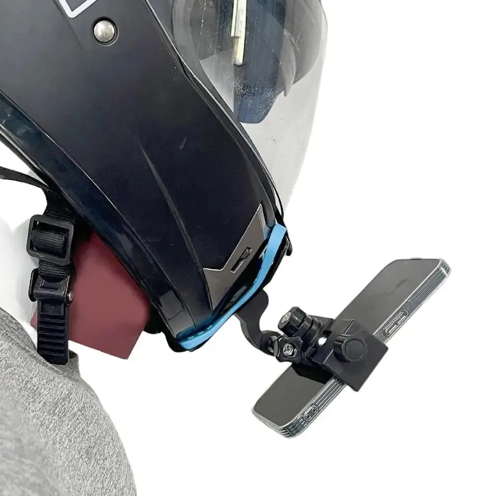 Helmet-mounted phone holder in landscape mode for hands-free motorcycle video recording.