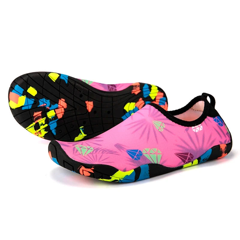 Colorful pink and black unisex aqua shoes with slip-on style, perfect for beach activities and quick-drying fitness.