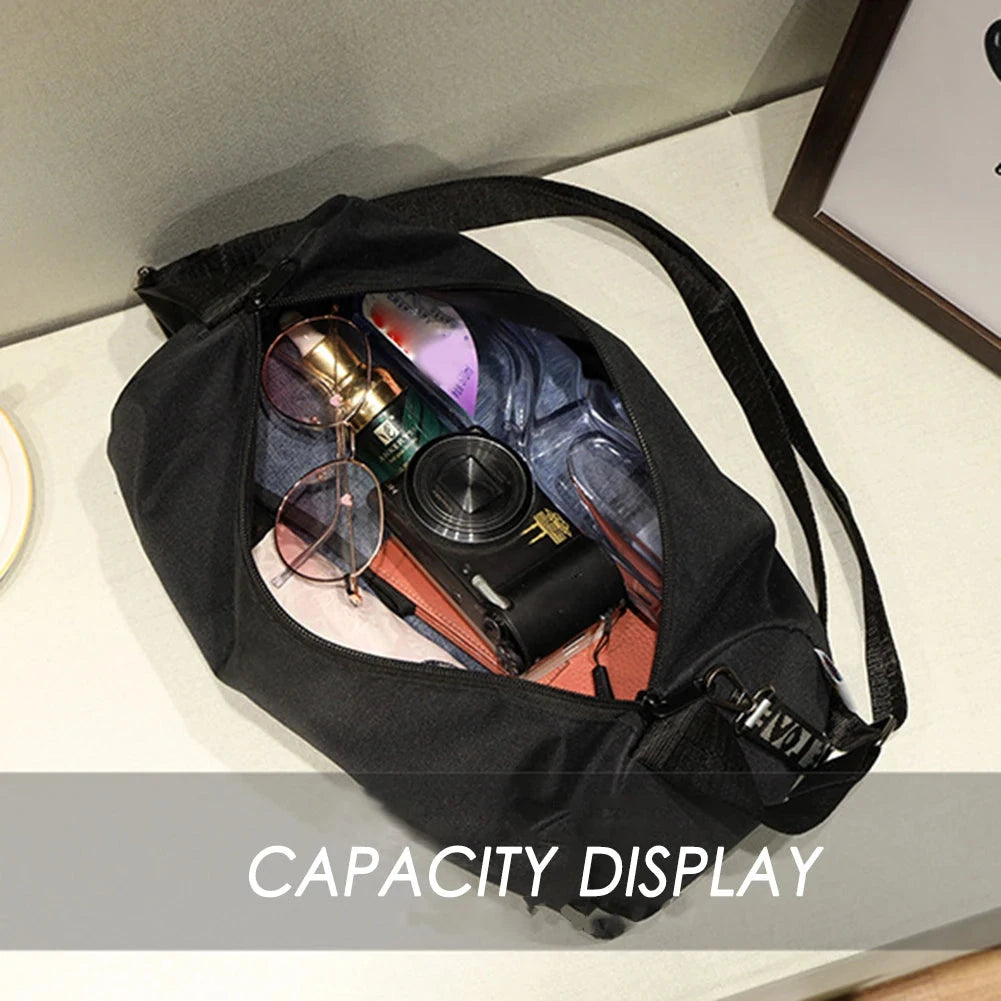 Open black gym bag displaying interior capacity with sunglasses, camera, and cosmetics, ideal for travel and fitness storage.