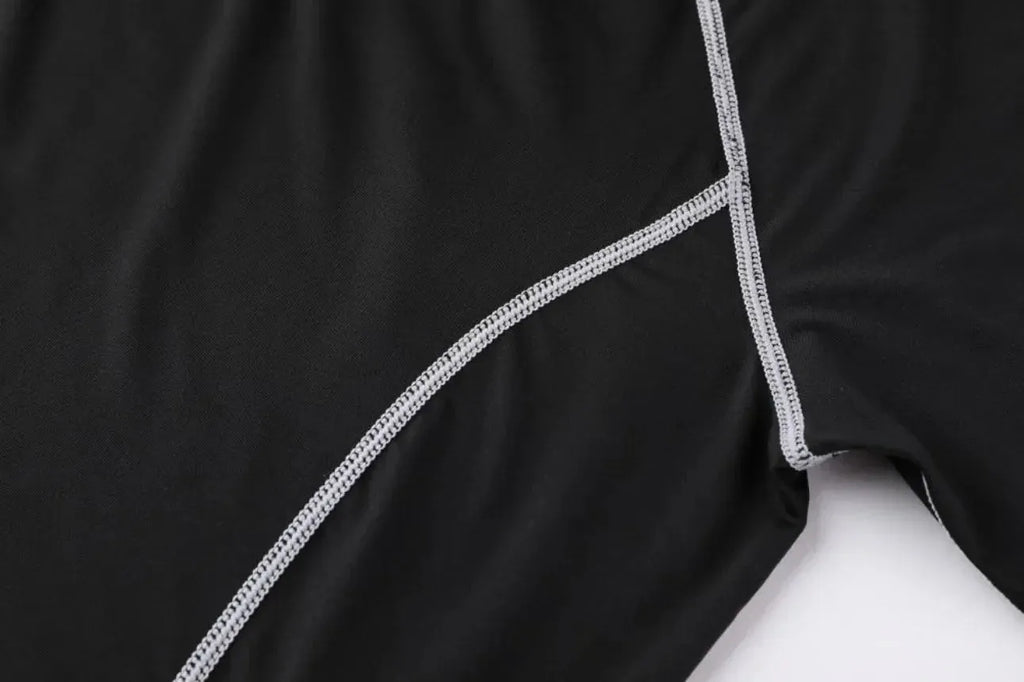Detailed stitching on black Men Bodybuilding Sportswear Clothes Fitness Suit, highlighting quality and durability for workouts.