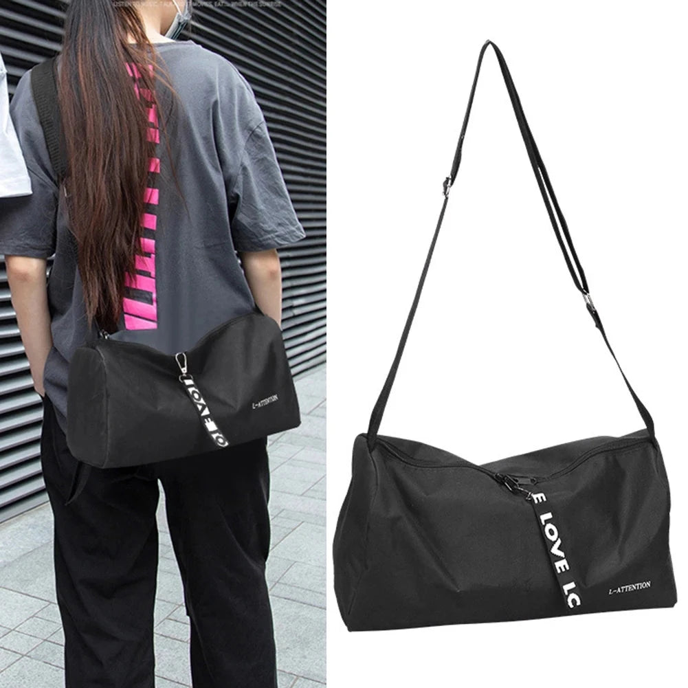 Unisex model wearing black portable outdoor gym bag with adjustable strap, showcasing its casual and sporty design for travel.