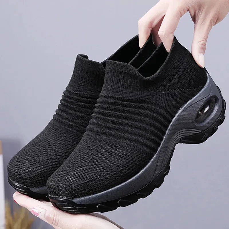 Women Sneakers Fashion Breathable Walking Mesh Platform Shoes in black with slip-on design and cushioned sole for gym or casual wear.