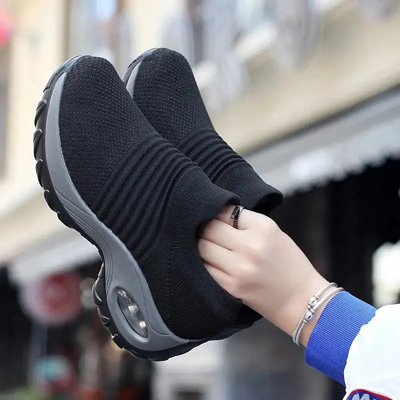 Women Sneakers Fashion Breathable Walking Mesh Platform Shoes in black with slip-on design and cushioned sole for gym or casual wear.